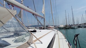 A marina with multiple sailboats docked, clear skies, and calm waters. - Sun-Kissed Sailing Adventure in the Ionian Islands, Lefkada (Lefkada)