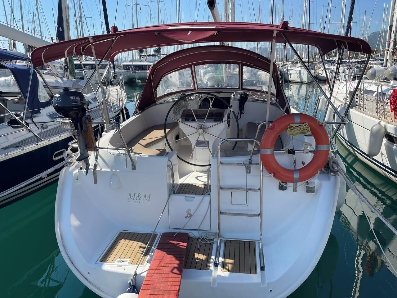 A boat with a Yamaha outboard motor, a life preserver, and a 'M&M Split' sign.