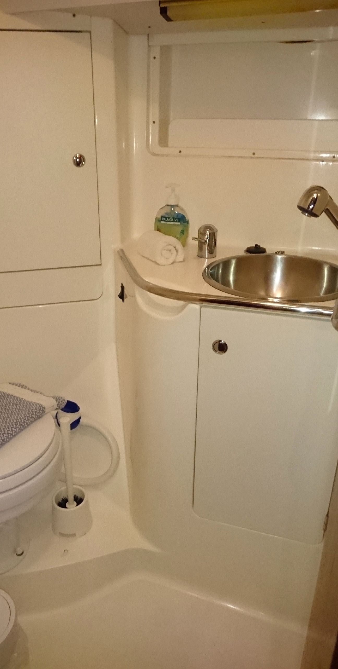 A bathroom with a toilet, sink, and shower.
