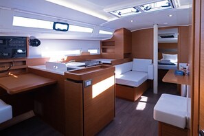 A compact, well-lit interior with a central seating area, a small kitchenette, and a control panel. - Sun-Kissed Sailing Adventure in Split, Croatia (Split)