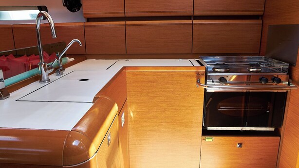 A compact kitchen with a sink, faucet, stove, and oven. - Sun-Kissed Sailing Adventure in Zadar, Croatia (Biograd na moru)