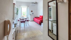 Una habitación con cama, escritorio, silla, mesa y armario.