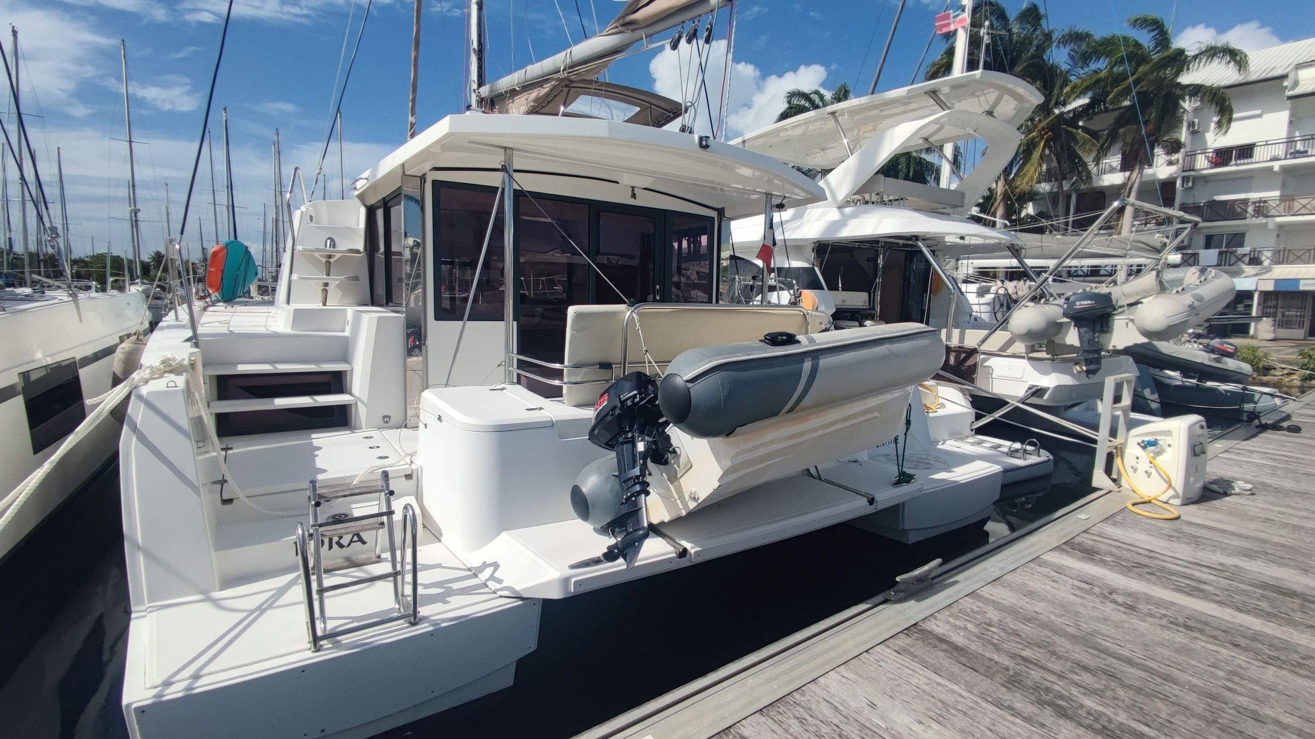 A marina with multiple yachts docked.
