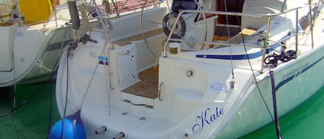 A boat docked at a marina with a name 'Kate' visible on the side.