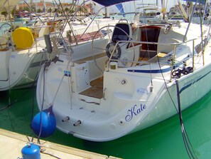 A boat docked at a marina with a name 'Kate' visible on the side.