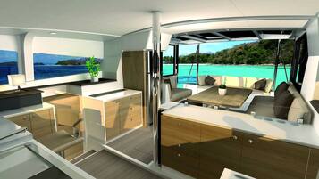 A modern interior with a kitchen, dining area, and seating with a view of the sea.