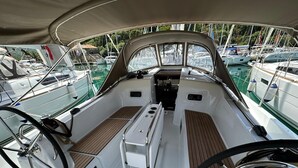 A boat deck with a steering wheel, a central console, and seating areas. - Dubrovnik Delight: A Sun-Kissed Sailing Experience (Komolac)