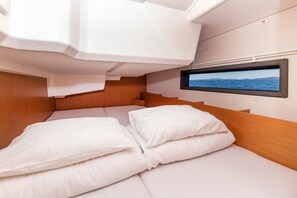 A cabin with a bed, a television screen, and a window with a view of the sea. - Sun-Kissed Sailing Adventure in Zadar, Croatia (Zadar)