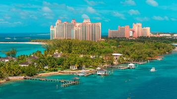 A coastal resort with multiple high-rise buildings, a pier, and a marina.