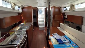 A compact kitchen with a stove, sink, and a small refrigerator. - Sun-Kissed Sailing Adventure in Zadar, Croatia (Bibinje)