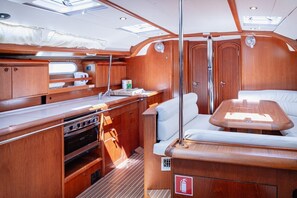 A compact galley with a stove, sink, and storage cabinets. - Sun-kissed Sailing Adventure in Split-Dalmatia, Croatia (Seget Donji)