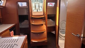 A compact interior with a bunk bed, a small kitchenette, and a toilet. - Sun-Kissed Sailing Adventure in Islas Sarónicas (Alimos)