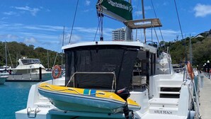 A yacht docked at a marina with a name 'NAMASTE' on the side. - Sun-Kissed Sailing Adventure in Gran Barrera de Coral from Playa Airlie, Queensland (Airlie Beach)