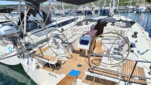 A sailboat with a wooden deck, a steering wheel, and a brand name 'GALA' on the side. - Sun-Kissed Sailing Adventure in Northern Croatia (Punat)