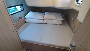 A compact, single-bed RV with a window providing a view of the outdoors. - Sun-Kissed Sailing Adventure in Northern Croatia (Punat)