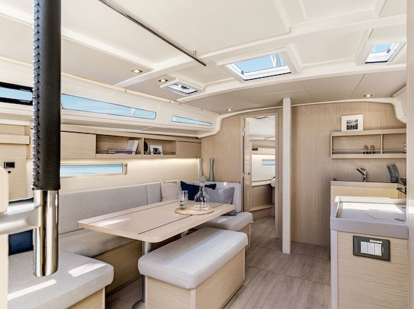 A modern interior with a dining area, seating, and built-in storage.