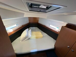 A compact, well-lit cabin with a single bed, a small window, and a ceiling vent. - Sun-Kissed Sailing Adventure in Northern Croatia (Punat)