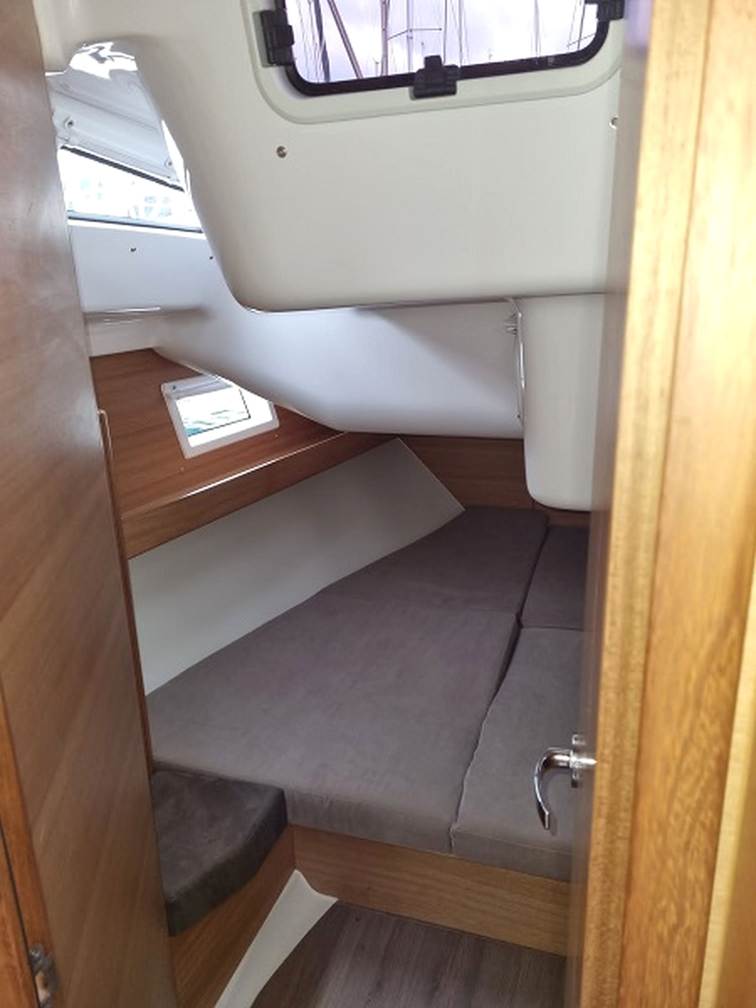 A compact interior with a bench seat, a small table, and a window.