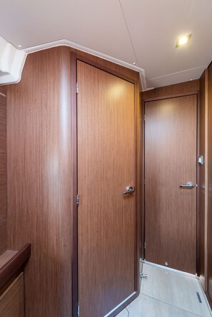 A corner of a room with wooden wardrobes and a ceiling light. - Sun-Kissed Sailing Adventure in the Ionian Islands, Lefkada (Lefkada)