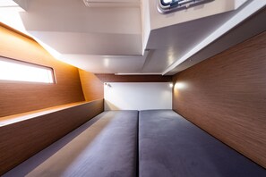 A modern interior with a wooden panel wall, a bench, and a bed. - Sun-Kissed Sailing Adventure in the Ionian Islands, Lefkada (Lefkada)