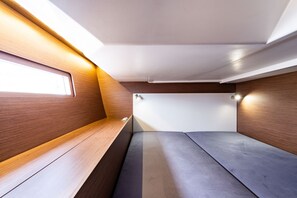 A compact, modern interior with a bench seating area, a small window, and built-in lighting. - Sun-Kissed Sailing Adventure in the Ionian Islands, Lefkada (Lefkada)