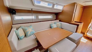 A compact interior with a sofa, a small table, and a bench.