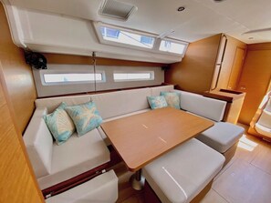 A compact interior with a sofa, a small table, and a bench.