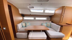 A compact interior with a sofa, a small table, and storage units.
