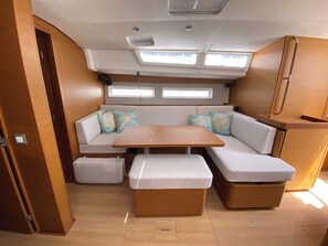 A compact interior with a sofa, a small table, and storage units.