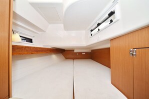 A compact, well-lit interior with a bed, storage cabinets, and a window. - Sun-Kissed Sailing Adventure in Zadar, Croatia (Zadar)