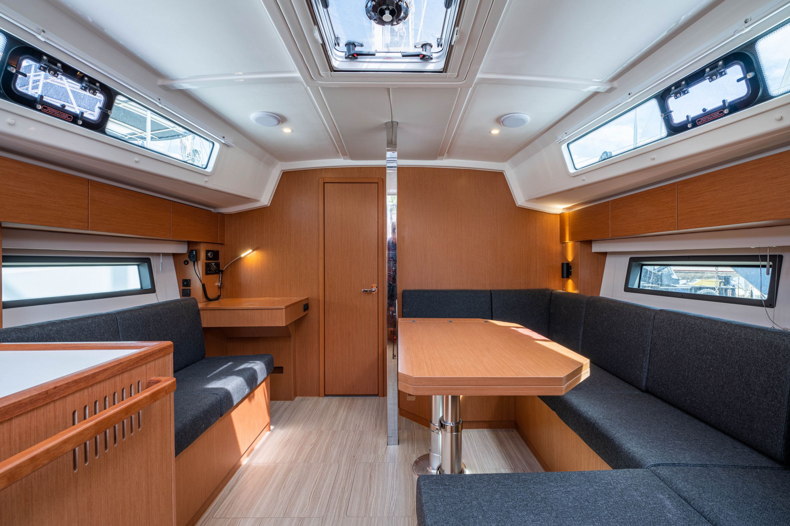 A compact interior with a central table, seating, and skylights.