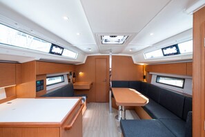 A compact interior with a central table, seating, and skylights. - Sun-Kissed Sailing Adventure in the Ionian Islands, Lefkada (Lefkada)