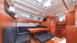 A compact galley with a dining table, seating, and built-in appliances. - Sun-Kissed Sailing Adventure in Zadar, Croatia (Zadar)