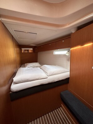 A compact, well-lit interior with a bed, storage cabinets, and a small window. - Sun-Kissed Sailing Adventure in Zadar, Croatia (Bibinje)