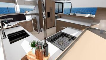 Una cocina moderna con estufa, pileta y encimera de madera.