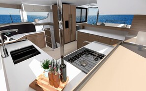 A modern kitchen with a stove, sink, and wooden countertop. - Caribbean Bliss: Sun-Soaked Sailing Adventure from San Martín, Anse Marcel (Anse Marcel)