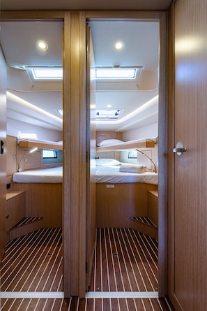 A compact, well-lit cabin with bunk beds, a skylight, and a small desk area. - Sun-Kissed Sailing Adventure in the Ionian Islands, Lefkada (Lefkada)