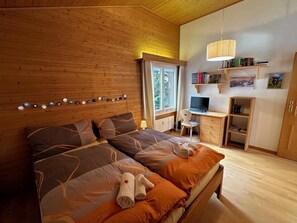 A bedroom with two beds, a desk, and a computer. - Hübeli (Streit) Appartement/Fewo, Dusche und Bad, WC 6-Bettwohnung by Interhome (Zweisimmen)