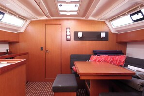 A compact interior with a kitchenette, a dining area, a sofa, and a small table. - Sun-Kissed Sailing Adventure in Zadar, Croatia (Biograd na moru)
