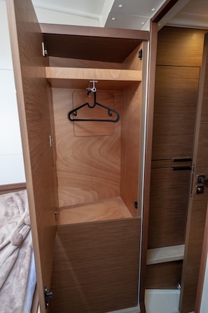 A wooden wardrobe with a hanging rod and a small shelf. - Sun-Kissed Sailing Adventure in the Ionian Islands, Lefkada (Lefkada)