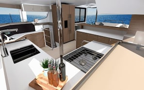 A modern kitchen with a stove, sink, and wooden countertop.