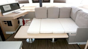 A compact room with a bed, a desk with a computer, and a fire extinguisher. - Sun-Kissed Sailing Adventure in Northern Croatia (Punat)