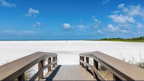 A wooden boardwalk leading to a beach with a clear sky. - South Seas - 2-bedroom Beachfront condo on Marco Island FL (Marco Island)