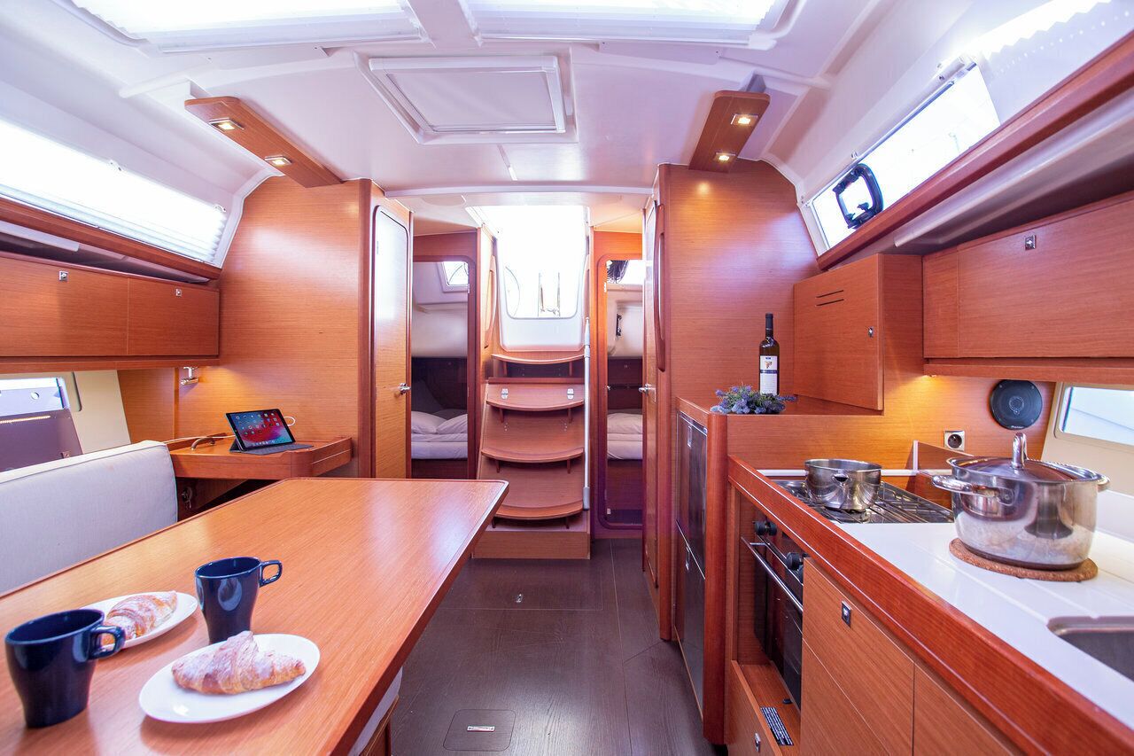 A compact kitchen with a dining area, a small seating space, and a window for natural light.
