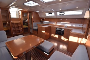 A compact galley with a sink, stove, and storage cabinets. - Sun-Kissed Sailing Adventure in Northern Croatia (Punat)