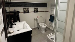 A bathroom with a white sink, a toilet, a glass shower enclosure, and a mirror. - NEMO Apartment by Ateya - L'Estaque (Marseille)