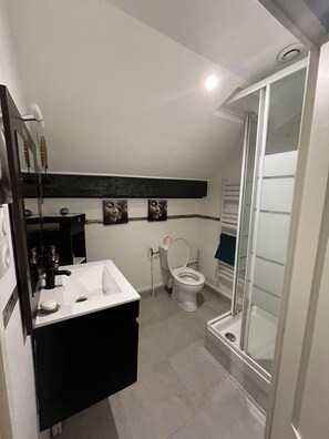 A bathroom with a white sink, a toilet, a glass shower enclosure, and a mirror. - NEMO Apartment by Ateya - L'Estaque (Marseille)