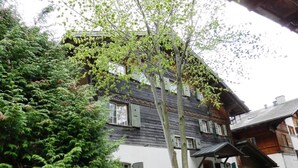 Ein traditionelles Holzhaus mit mehreren Fenstern und einem Balkon.