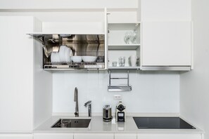 A modern kitchen with a dishwasher, a sink, a coffee maker, and a built-in oven. - Blueground | Zhengshou District, balcony, nr park (TPE-1) (Taipei)