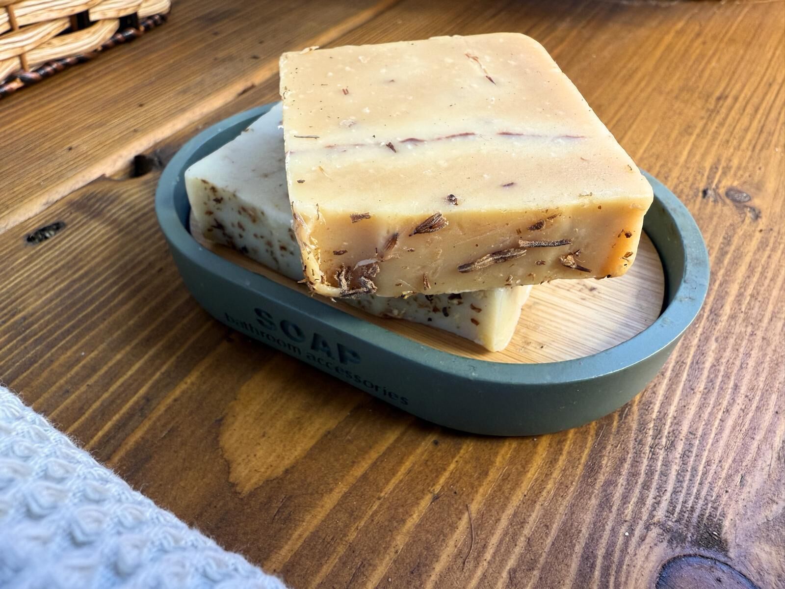 A bar of soap on a wooden surface.
